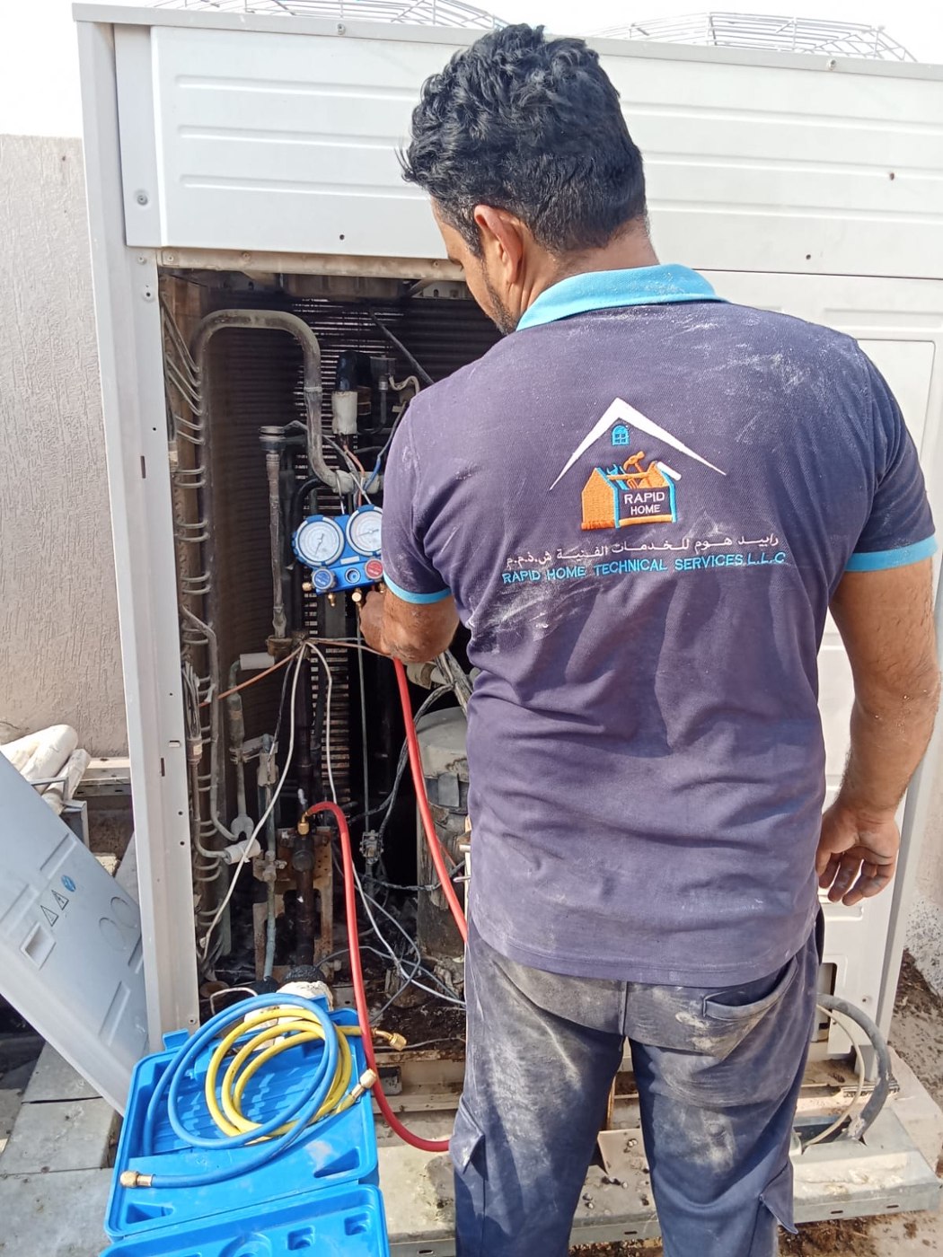 Rapid Home technician working on an AC unit in Dubai
