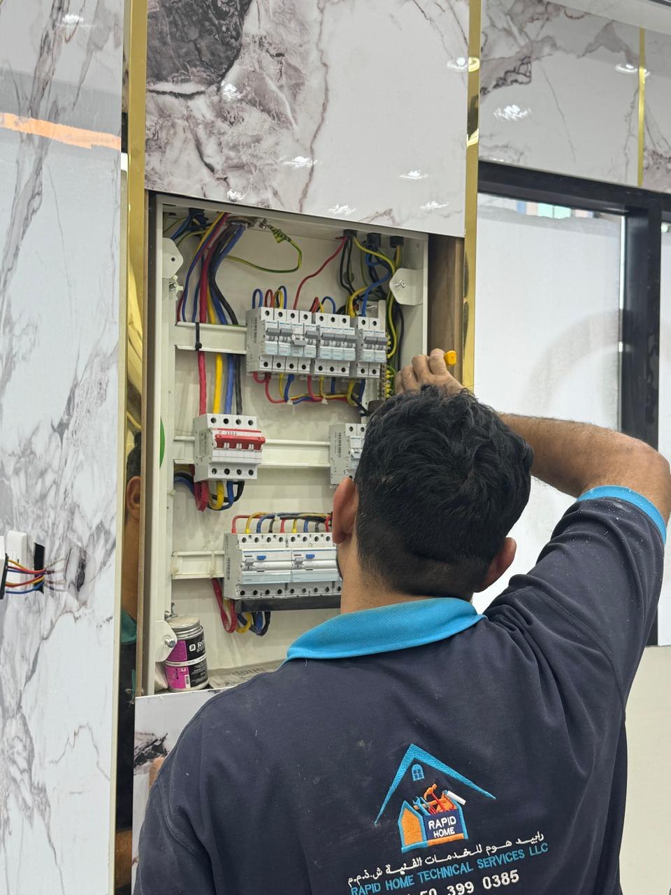 Rapid Home technician working on a distribution board