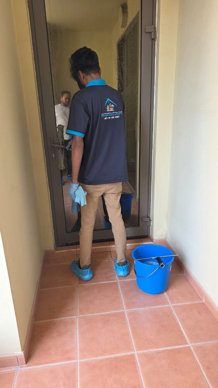 Rapid Home team member cleaning a glass door
